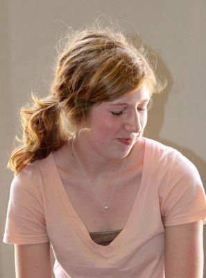 Natalie practically glows with satisfaction as she learns how to play the cajón.