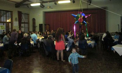 A host brother awaits the pinata as family members gather and visit  during the despedida.