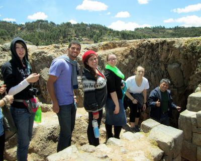 Lydia, Trevor, Frances, Jessica, Danielle and Willy head into a cave at Sacsayhuamán.