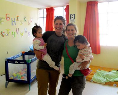 Elizabeth poses with fellow SSTer, Mariah, and twin girls who live at the Casa Luz orphanage in Ayacucho.