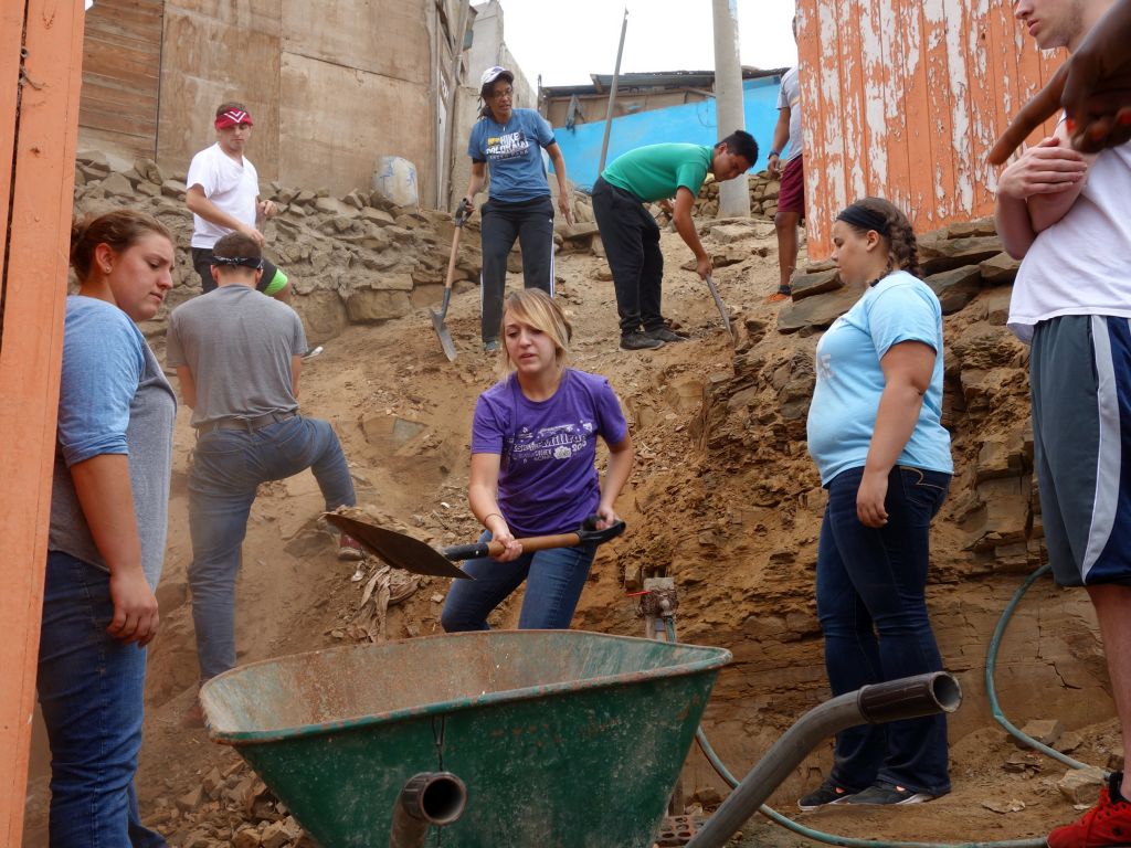 rocks and dirt were shoveled into wheelbarrows