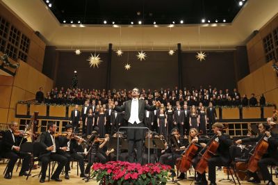 Scott Hochstetler, associate professor of music, leads the audience in a traditional Christmas carol during the 2014 “A Festival of Carols” performance at Goshen College. (Photo by Brian Yoder Schlabach)