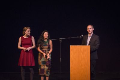 Duane Stoltzfus, professor of communication, announces the winners of the college’s 2016 C. Henry Smith Peace Oratorical Contest on March 15. Noemi “Mimi” Salvador (center) won first prize, and Christina Hofer (left) was runner-up. (Photo by Hannah Sauder)