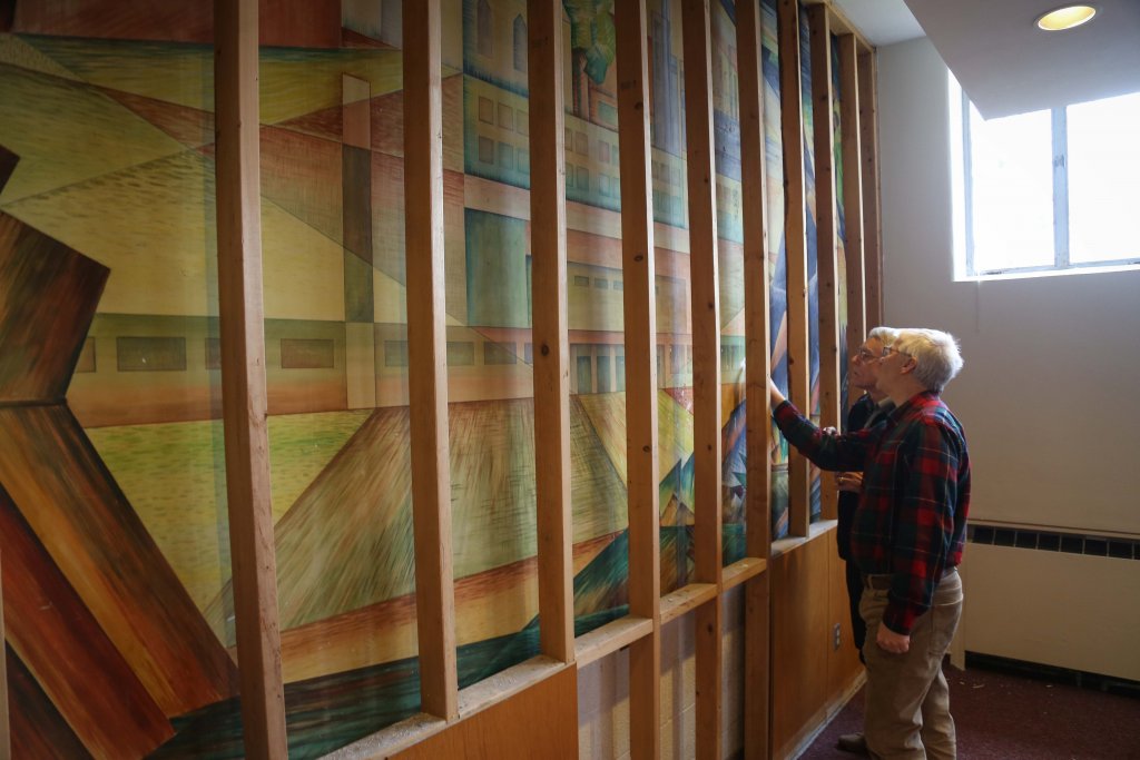 Two men looking at a mural